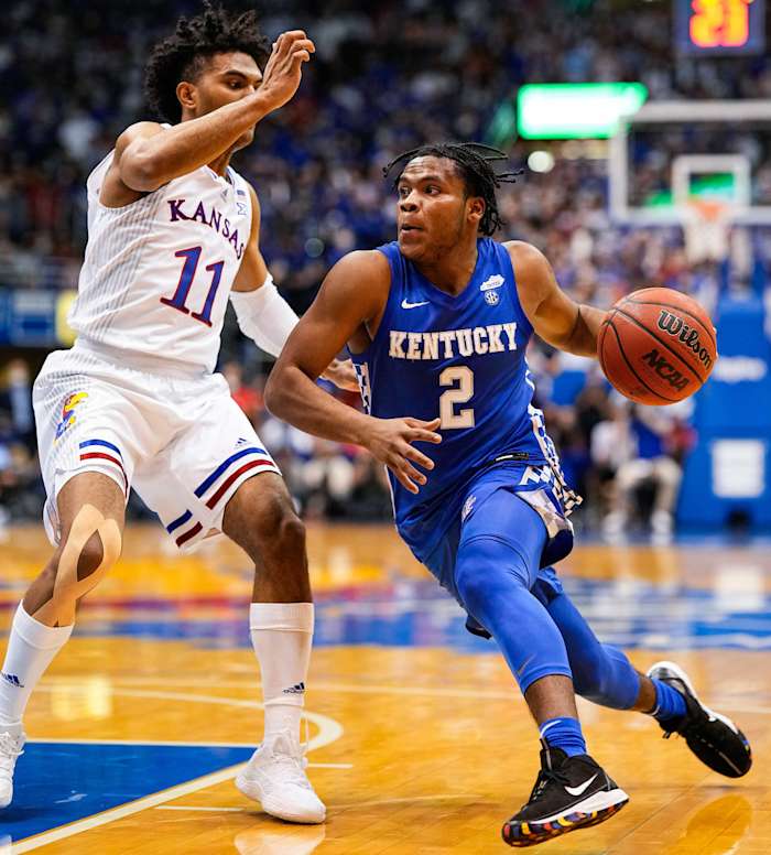 Kentucky Wildcats guard Sahvir Wheeler (2) drives against Kansas Jayhawks guard Remy Martin (11) during the first half at Allen Fieldhouse.